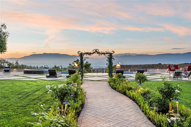 view of community with a mountain view and a yard