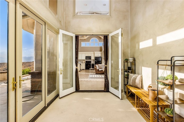 doorway with french doors and a high ceiling