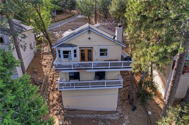 back of house with a balcony