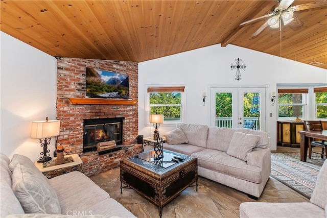 living room with vaulted ceiling with beams, french doors, wood ceiling, a brick fireplace, and ceiling fan