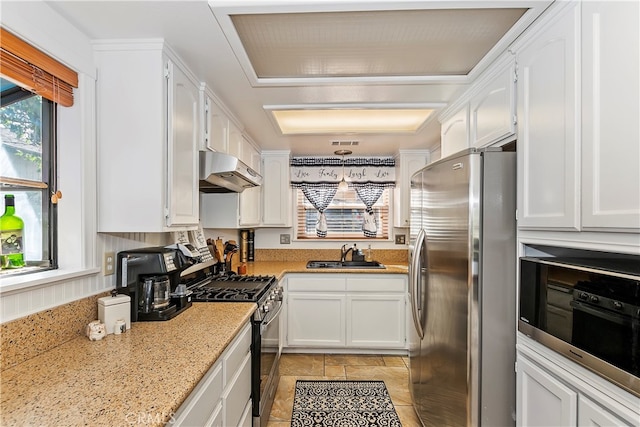 kitchen with white cabinetry, stainless steel appliances, sink, and pendant lighting