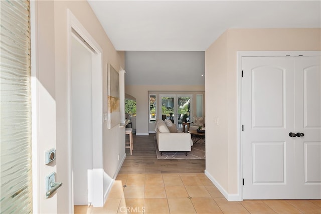 foyer with light hardwood / wood-style flooring and french doors