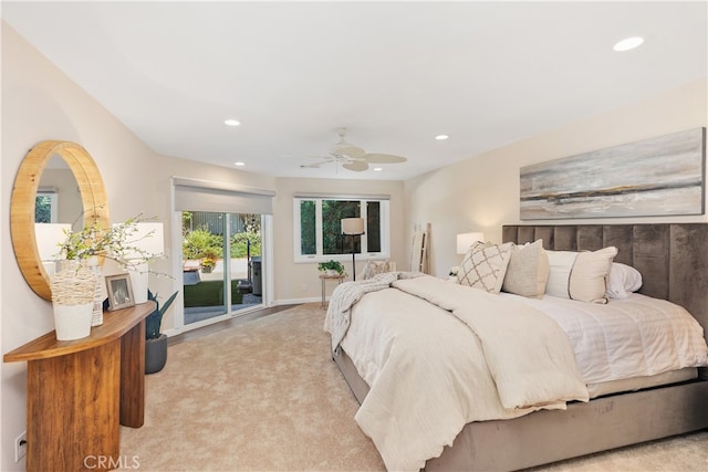 bedroom with access to outside, light colored carpet, and ceiling fan