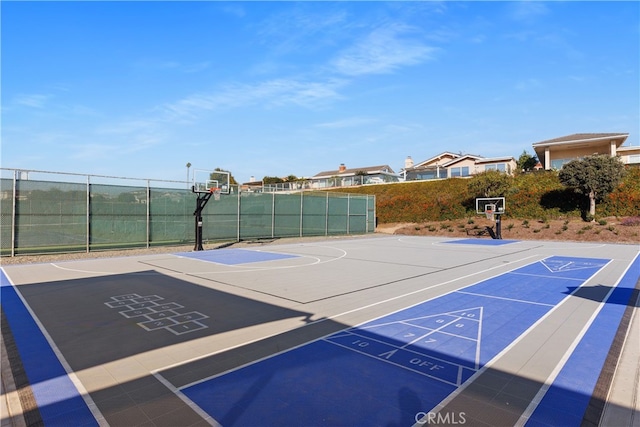 view of home's community with basketball hoop