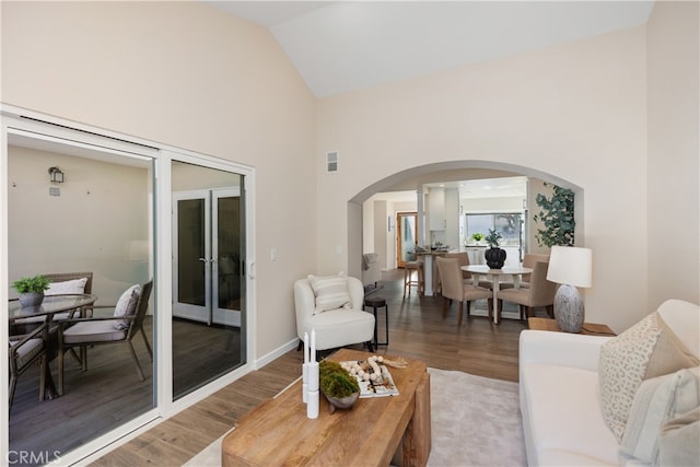 living room featuring vaulted ceiling and hardwood / wood-style floors