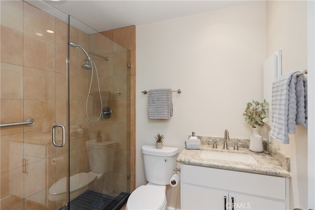 bathroom with vanity, toilet, and walk in shower