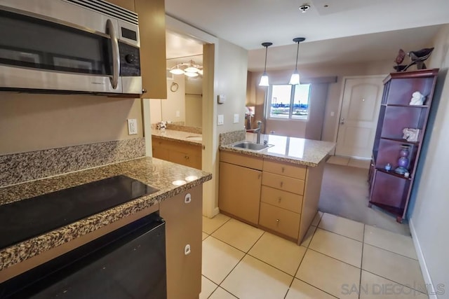 kitchen with light brown cabinets, sink, decorative light fixtures, light tile patterned floors, and appliances with stainless steel finishes