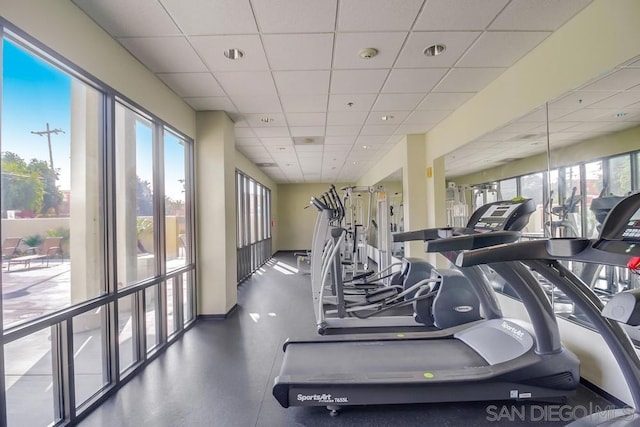 gym with a paneled ceiling