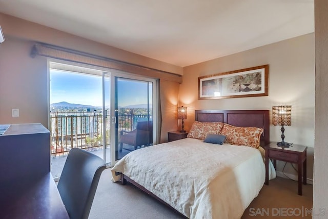 bedroom featuring access to outside and a mountain view