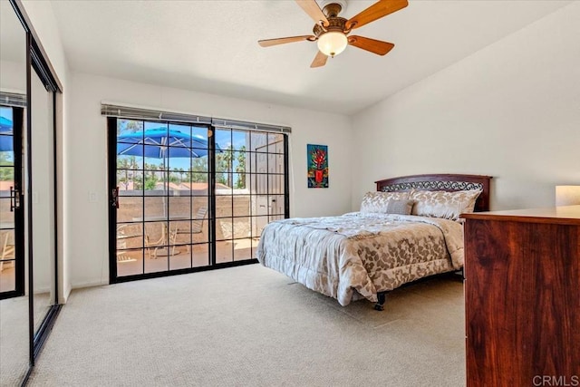 carpeted bedroom with ceiling fan and lofted ceiling