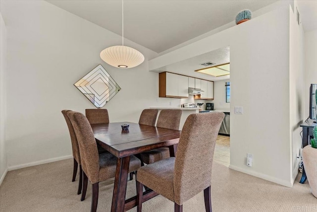 dining space with light colored carpet