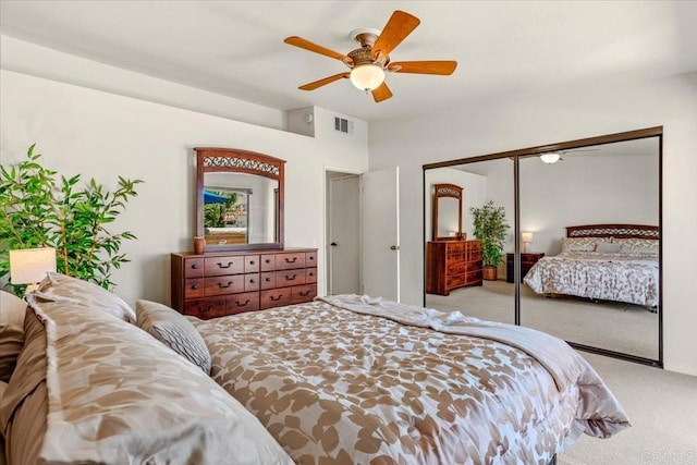 bedroom featuring ceiling fan, light colored carpet, and a closet