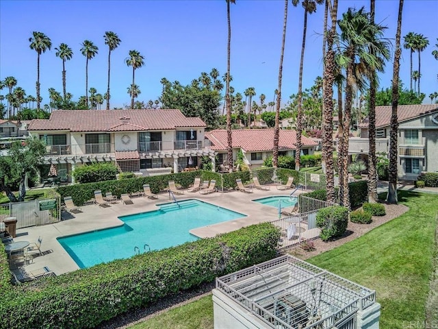 view of swimming pool featuring a patio area and a yard