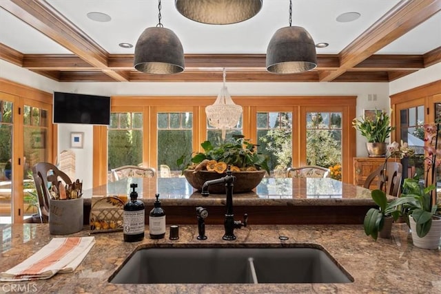 kitchen with hanging light fixtures, french doors, sink, and coffered ceiling