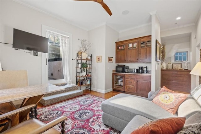 living room featuring ceiling fan, crown molding, light hardwood / wood-style floors, and beverage cooler