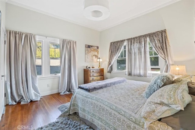 bedroom featuring ornamental molding and wood-type flooring