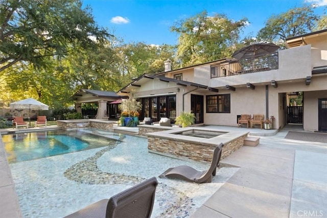 view of swimming pool featuring a patio area and an in ground hot tub