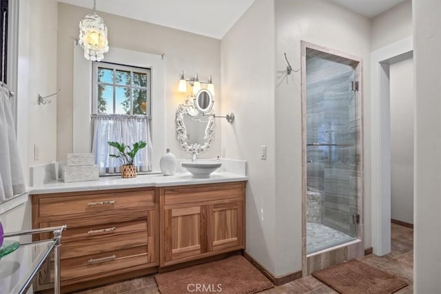 bathroom featuring tile patterned floors, an enclosed shower, and vanity