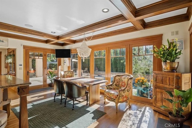 sunroom featuring a wealth of natural light, beam ceiling, french doors, and an inviting chandelier