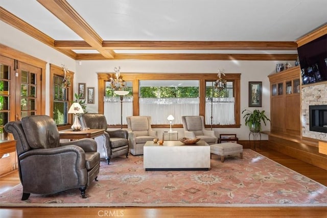 living room with a fireplace, beam ceiling, coffered ceiling, hardwood / wood-style flooring, and ornamental molding