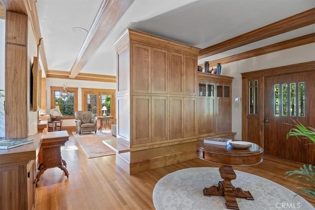 entrance foyer featuring light wood-type flooring and crown molding