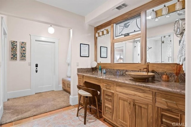 bathroom featuring tile patterned flooring and vanity