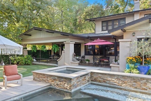 back of property with an outdoor hangout area and a patio