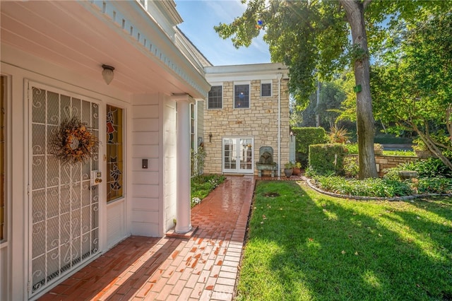 doorway to property with french doors and a yard