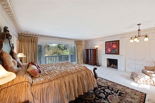 bedroom featuring carpet floors, access to exterior, and a chandelier