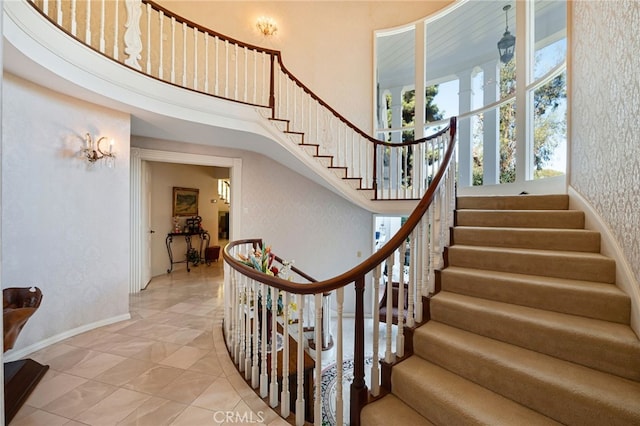 stairway featuring a high ceiling