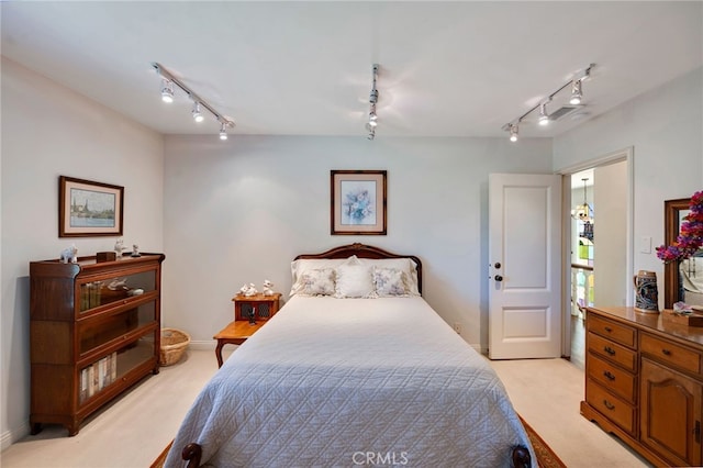 bedroom featuring light colored carpet