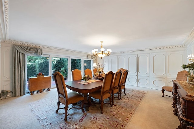 carpeted dining space featuring crown molding and a notable chandelier