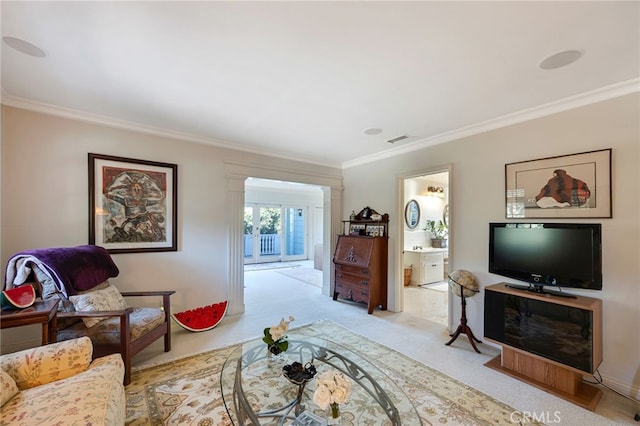 carpeted living room with ornamental molding