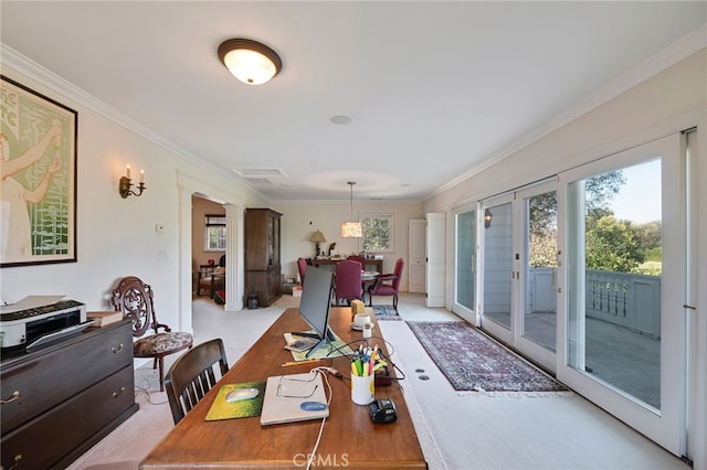 carpeted dining space featuring ornate columns, crown molding, and french doors