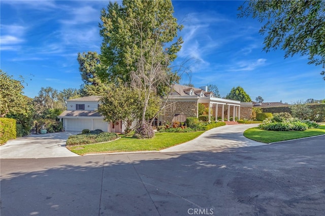 view of front of house featuring a garage and a front lawn