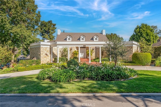 new england style home featuring a front yard