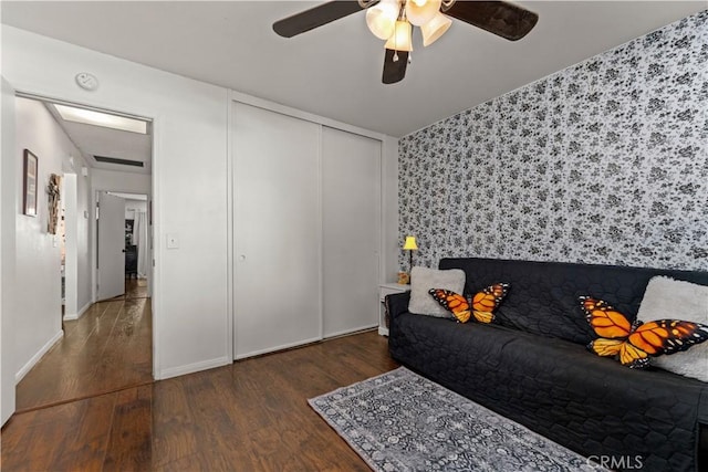 interior space featuring ceiling fan and dark wood-type flooring