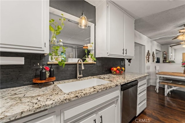 kitchen with backsplash, white cabinets, dark wood-type flooring, sink, and dishwasher