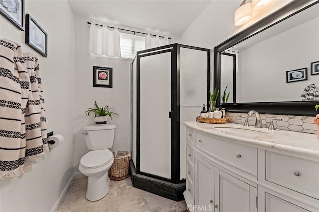 bathroom featuring decorative backsplash, vanity, toilet, and a shower with door