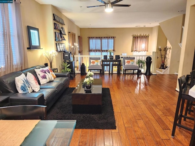 living room featuring hardwood / wood-style floors and ceiling fan