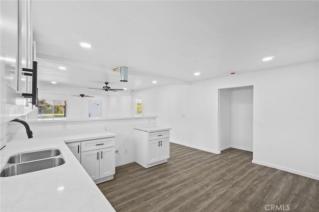 kitchen featuring ceiling fan, sink, dark hardwood / wood-style floors, and white cabinets