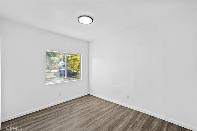 unfurnished room featuring dark wood-type flooring