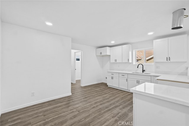 kitchen featuring sink, white cabinetry, and dark wood-type flooring