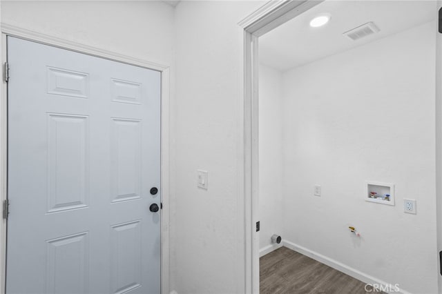 clothes washing area with hookup for a gas dryer, dark hardwood / wood-style floors, and washer hookup