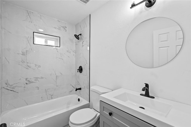 full bathroom featuring vanity, tiled shower / bath combo, and toilet