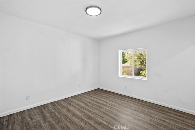 unfurnished room featuring dark hardwood / wood-style floors