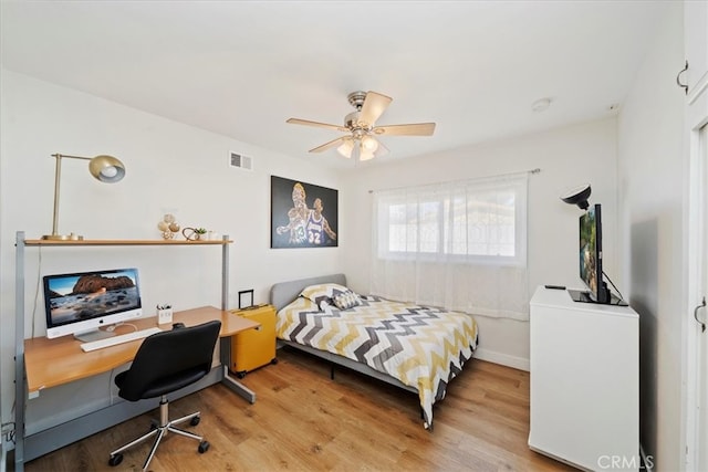 bedroom with light wood-type flooring and ceiling fan