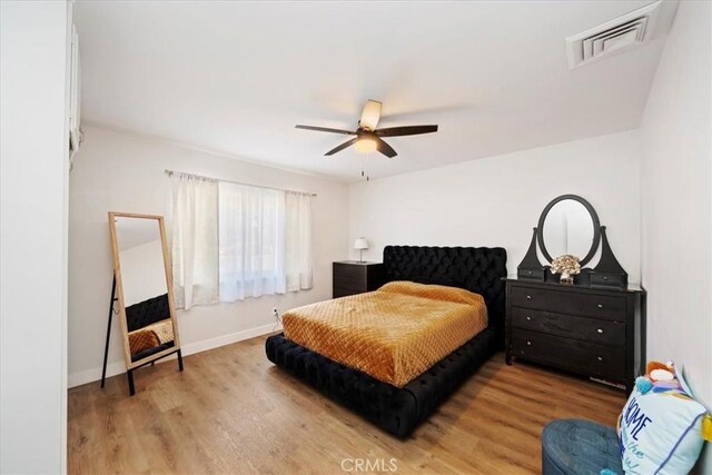 bedroom with hardwood / wood-style flooring and ceiling fan