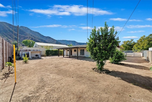 rear view of property featuring a mountain view