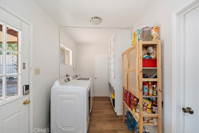 laundry room with washer and dryer and hardwood / wood-style flooring